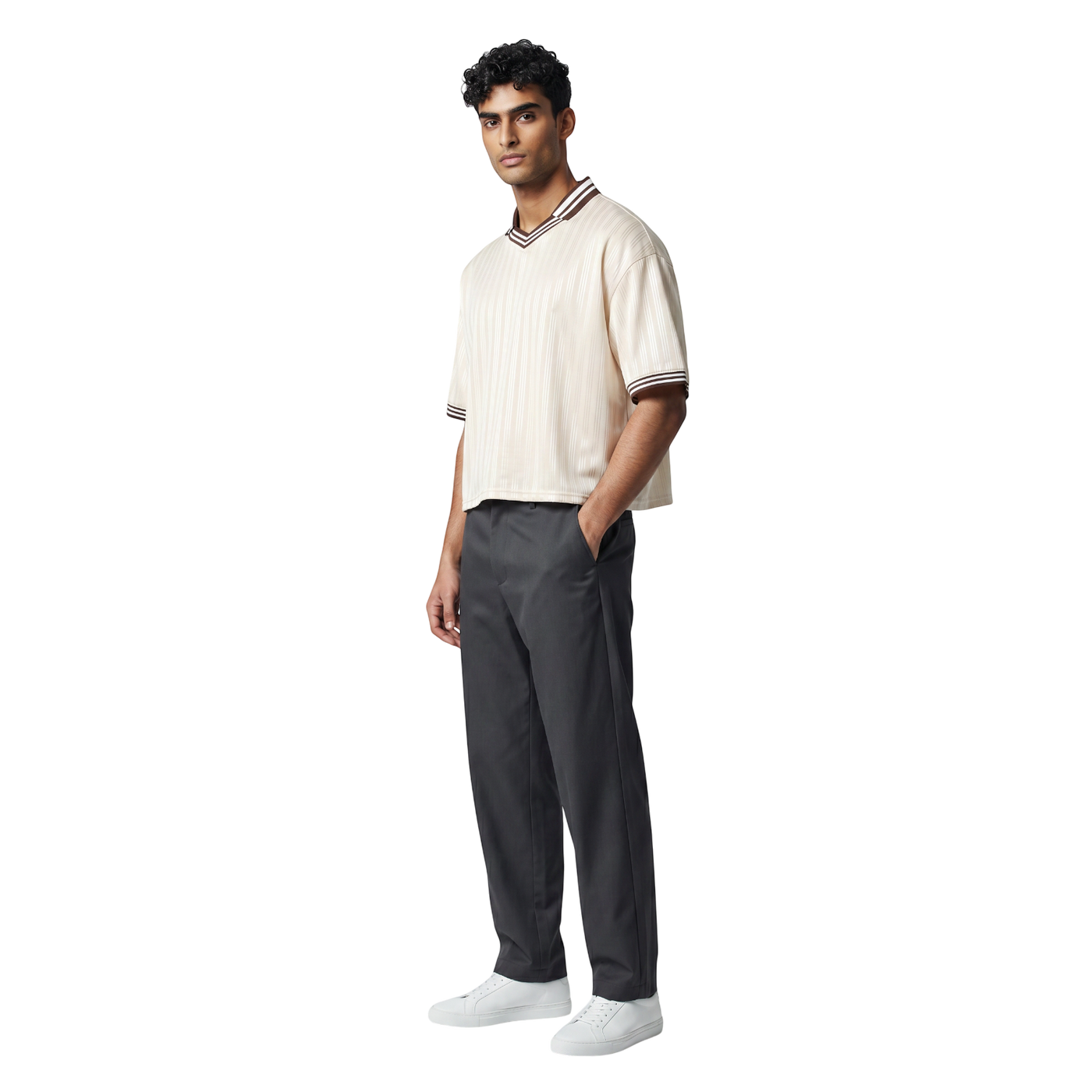 NILO Sequence striped polo tee in cream with brown trim worn by a male model with dark grey trousers and white sneakers