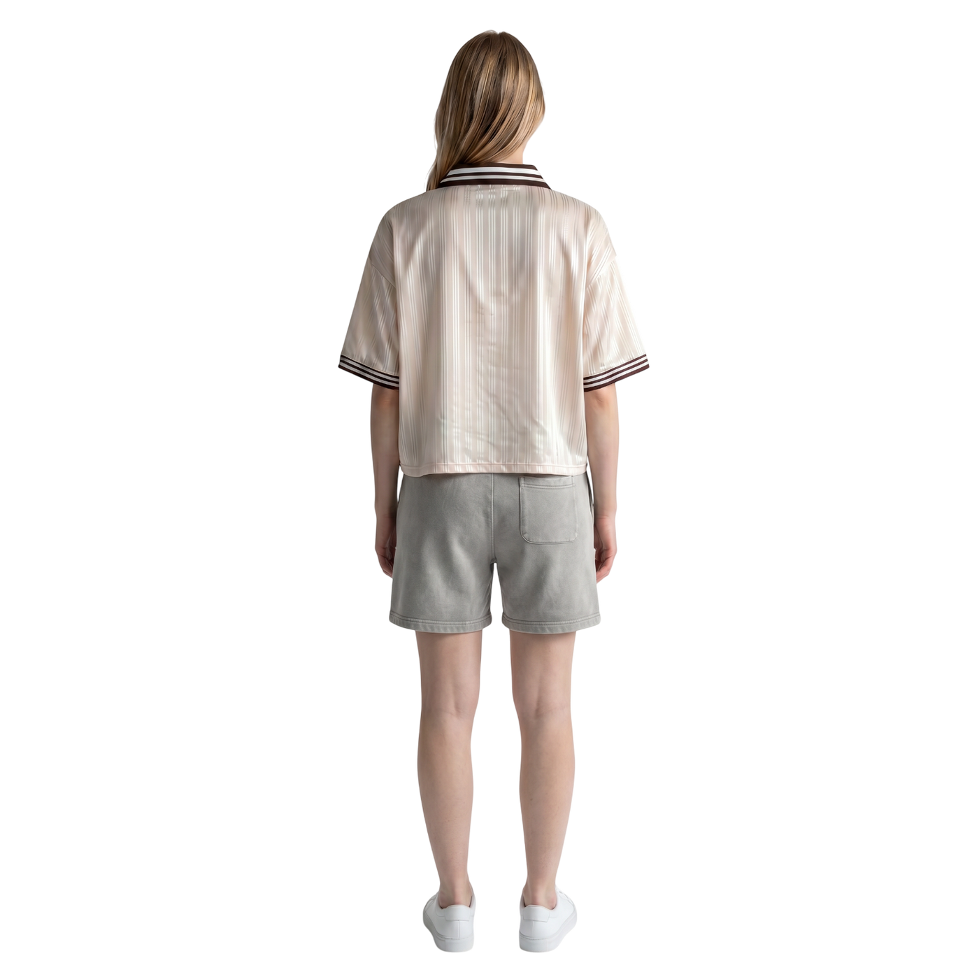 Back view of a woman wearing a NILO beige striped polyester polo tee with relaxed fit and grey shorts