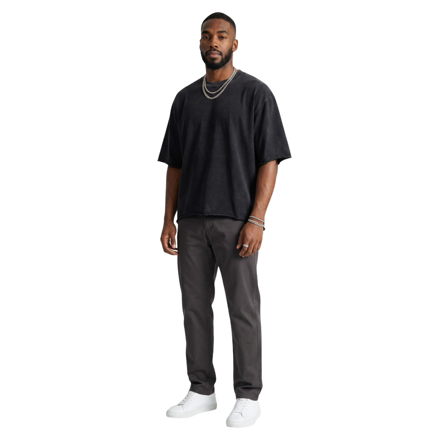 NILO Director snow-washed black boxy tee with raw edges in heavyweight cotton worn by a man
