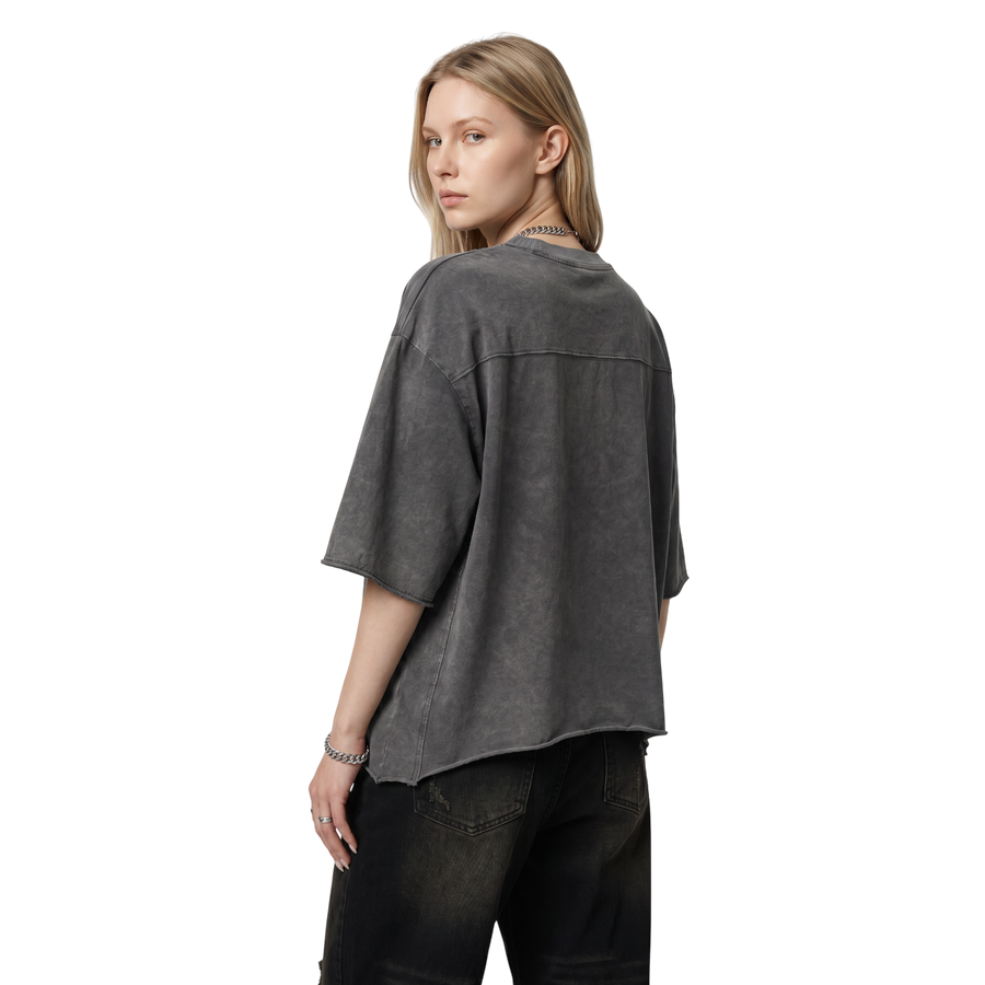 NILO Director snow washed boxy tee in charcoal grey heavyweight cotton with raw edges worn by a blonde model