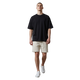 NILO Frame Loose Tee in black cotton with drop shoulders worn by a model with beige shorts and white sneakers