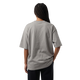 NILO Frame Loose Tee in grey cotton with drop shoulders, shown from the back on a model against a black background.