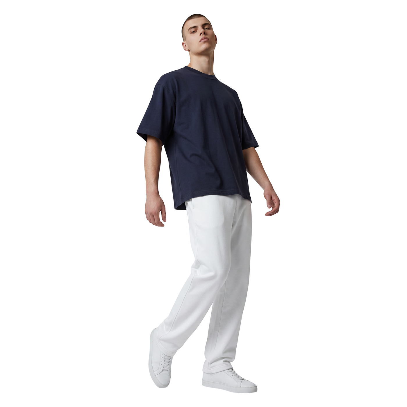 NILO Studio Heavyweight Tee in navy blue cotton with drop shoulders worn by a model with white joggers and sneakers.