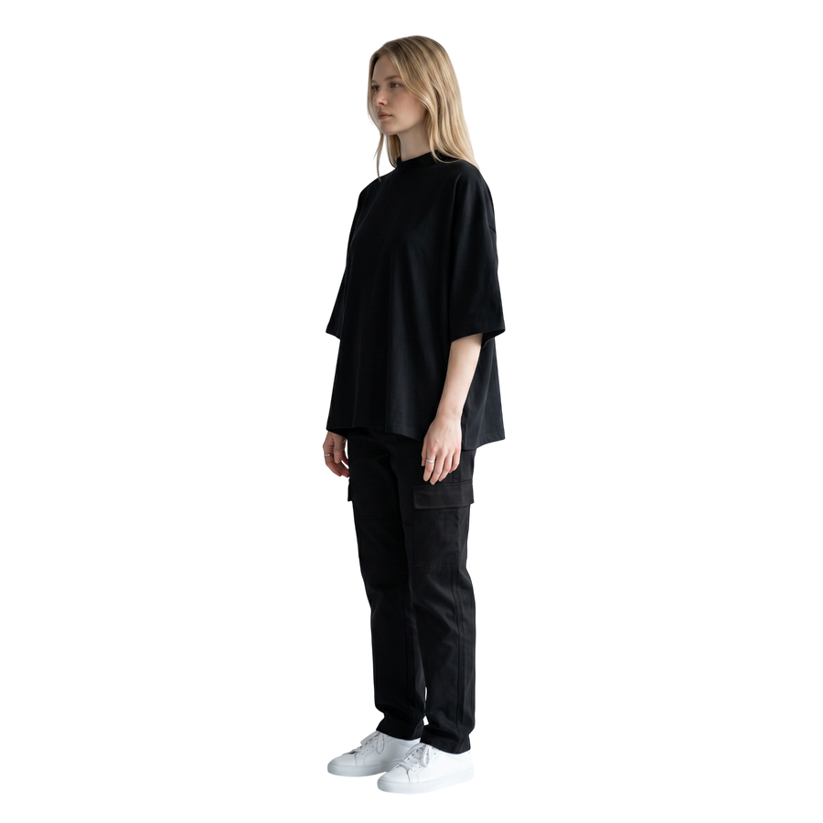 NILO Vision oversized black boxy tee in heavyweight cotton worn by a model in a side profile view